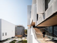 a person walking down a walkway between two buildings