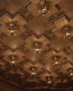 the ceiling is made up of wooden panels and chandeliers with lights on them