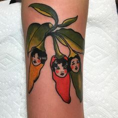 a tattoo on the leg of a woman with three children hanging from a banana tree