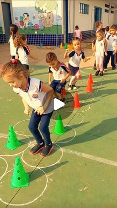 several children are playing with cones on the court