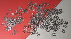 a bunch of metal rings sitting on top of a red table