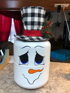 a snowman canister sitting on top of a counter