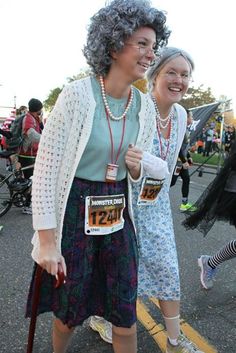 two women are walking down the street together