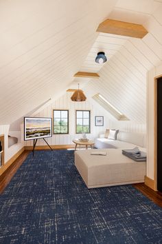 a living room with white walls and blue carpeted flooring in an attic style home