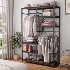 a room with a bed, chair and shelves filled with clothes