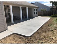 a concrete patio in front of a house