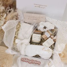 a gift box filled with personal care items on top of a white cloth covered table