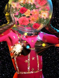 a woman with flowers on her head and body in front of a space filled with stars