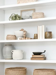 some white shelves with baskets and books on them