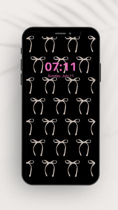 an iphone case with black and white bows on the front, and pink text that reads 1x0