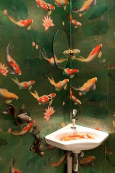 there is a sink with goldfish on it in this bathroom wallpapered area