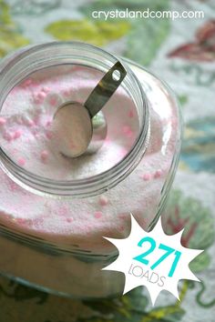 a jar filled with pink powder and a spoon