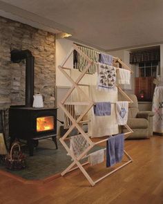 a living room filled with furniture and a fire place in the middle of it's floor