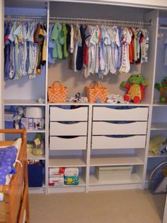 a baby's nursery closet with lots of clothes hanging on the rails and drawers