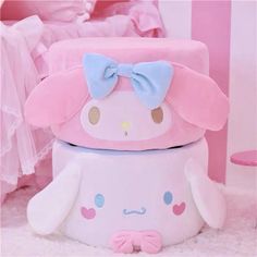 two pink and blue boxes with bows on them, one has a face in the middle