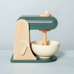 a wooden mixer with a white bowl in front of it