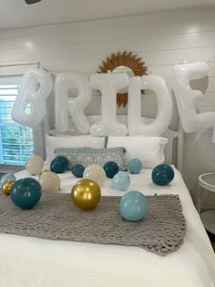 balloons are arranged on the bed in front of an air - filled balloon that says bride