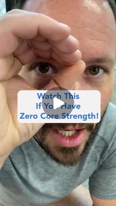 a man holding up a business card that says, watch this if you have zero core strength