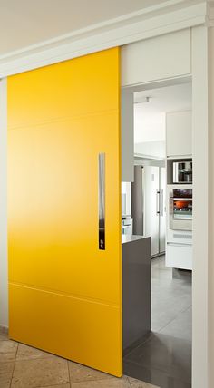 an open yellow door in the middle of a room