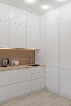 a kitchen with white cabinets and wooden counter tops