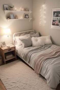 a bedroom with a bed, nightstand and pictures on the wall