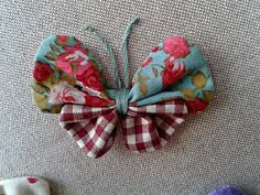 three pieces of fabric with flowers and bows on the top one is blue, red, white and pink