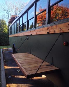 the back end of a bus parked in front of a house