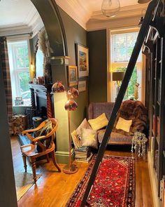 a living room filled with furniture and lots of windows