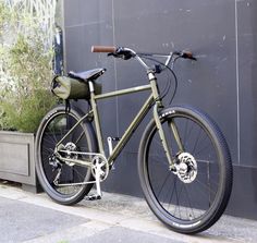 a green bike parked next to a building