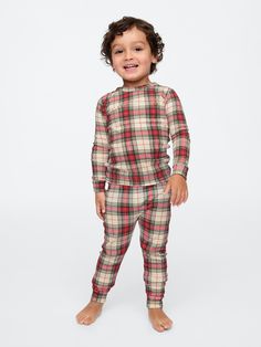 Soft cotton pajama top and pants set with a cozy brushed interior.  Crewneck.  Long sleeves.  Certain styles have embroidered Brannan Bear at chest.  Elasticized waist at PJ pants.  Assorted allover Holiday-themed prints.  Made with 100% organically grown cotton, which is grown without the use of synthetic pesticides and fertilizers.  This product was made in a factory that runs the Gap Inc.  P. A. C. E.  Personal Advancement & Career Enhancement) program.  P. A. C. E.  is our educational progra Baby Christmas Pajamas, Family Pjs, Matching Family Pajamas, Family Christmas Pajamas, Baby Christmas, Top And Pants Set, Toddler Christmas, Pj Pants, Boys Pajamas