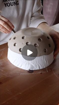 a person is making a sculpture out of clay