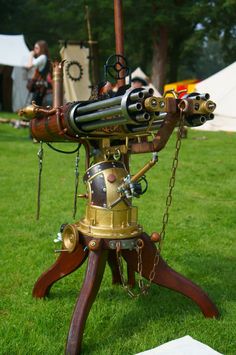 an old fashioned machine sitting on top of a green field