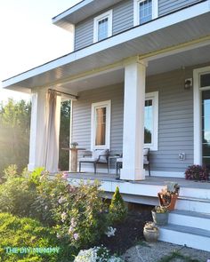 a house that has some flowers on the front porch