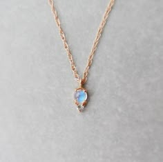 This tiny moonstone and tanzanite necklace is the perfect addition to your neck story, or for the delicate and dainty jewelry lover who believes that less is more, wear it alone. Details: (Option 1: Moonstone with Aquamarine) 14k gold (available in yellow gold, rose gold, or white gold) Moonstone measures about 3mm Aquamarine measures about 2mm OR (Option 2: Moonstone with Amethyst) 14k gold (available in yellow gold, rose gold, or white gold) Moonstone measures about 3mm Amethyst measures about