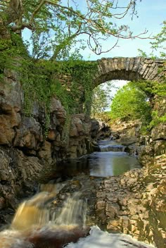 a stone bridge over a small river