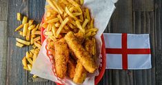 fish and fries on a red plate with a danish flag in the backgroud