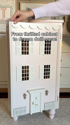 a white doll house with the words from thrifted cabinet to dream dollhouse