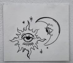 a drawing of an eye and the moon with stars around it on a white paper