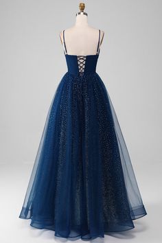 a dress on a mannequin dummy with blue tulle and sequins