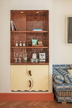 a living room with a couch, coffee table and bookshelf on the wall