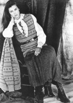 an old photo of a woman sitting on a chair with a scarf around her neck