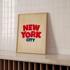 a new york city sign is displayed on the wall next to a radiator