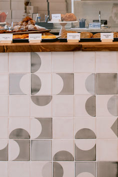 The front of a cafe counter in California - tiles in subtle gray. Gray Tiles, Cafe And Bakery, Cafe Counter, Bar Fronts, Bakery Design, Grey Tiles, Oakland California, Bakery Cafe