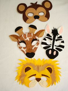 four masks with different animals and zebras on them, one has a giraffe, the other is a lion