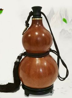 a brown vase sitting on top of a white table