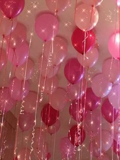 pink and red balloons hanging from the ceiling