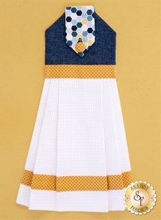 a white dress with blue and yellow stripes on the bottom, and a collared neckline