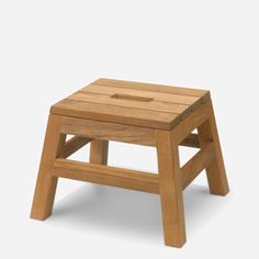 a small wooden stool on a white background