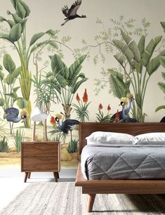 a bedroom with tropical wallpaper and two nightstands