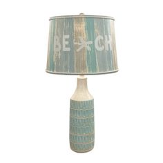 a table lamp with a blue and white shade that says be ghi on it